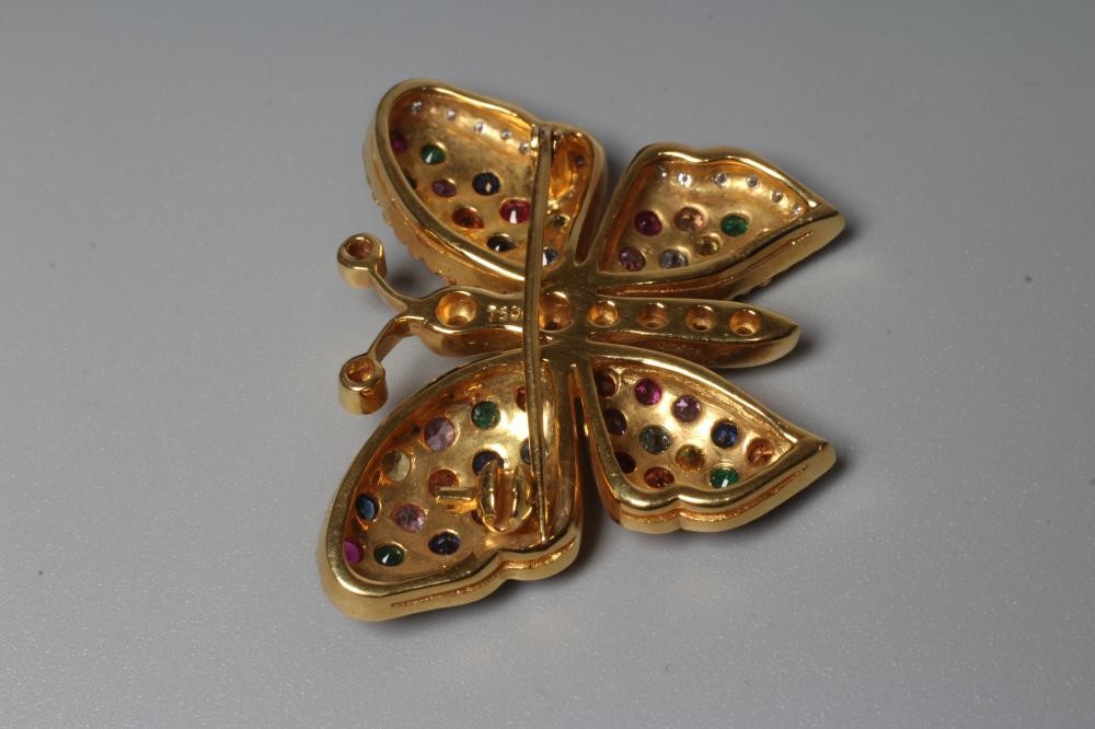 A MULTI-GEM BUTTERFLY BROOCH with ruby set antennae, diamond body and coloured gem wings, stamped Image