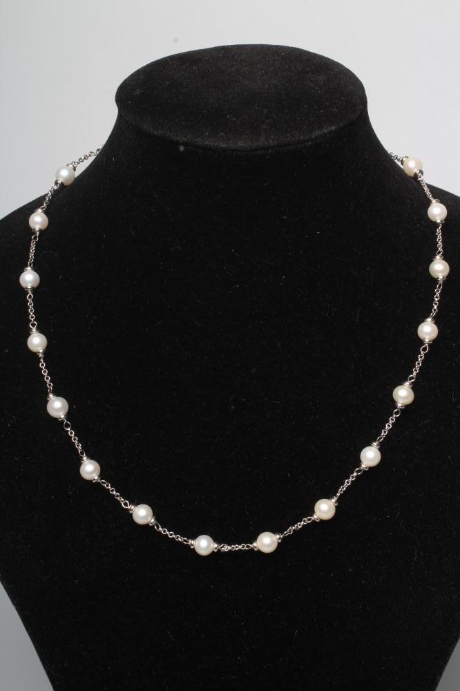 A WHITE CHAIN NECKLACE with twenty cultured pearl spacers to a lobster clasp, stamped 750 Image