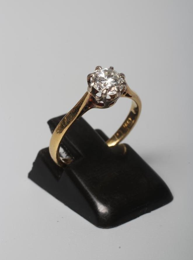 A SOLITAIRE DIAMOND RING, the brilliant cut stone of approximately 0.70cts, claw set to a plain Image