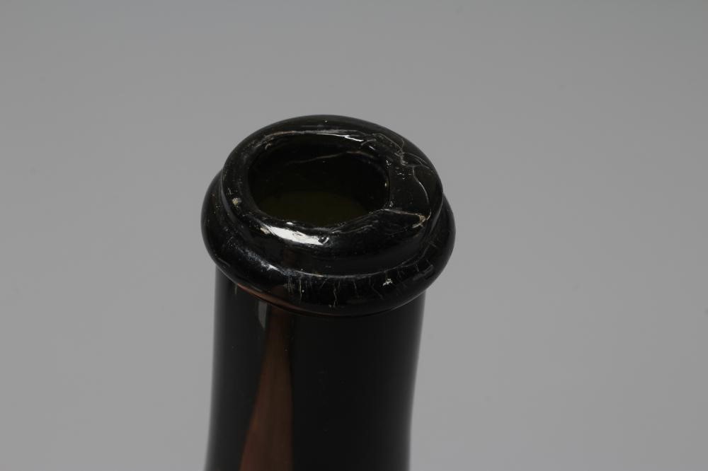 A GREEN ONION GLASS BOTTLE, mid 18th century, of typical form with single ring neck, plain deep kick Image