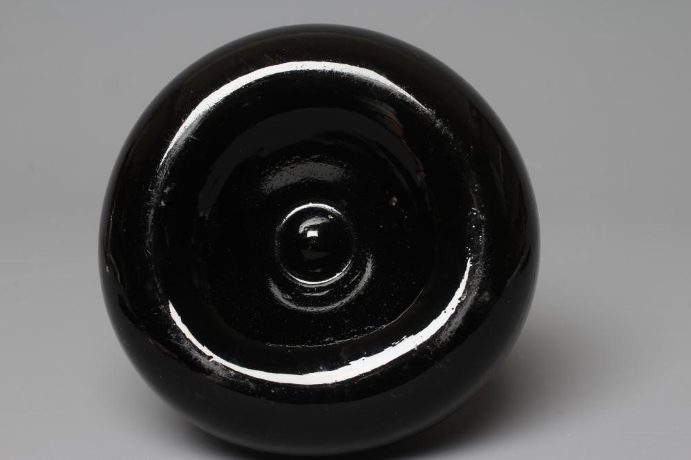 A GREEN ONION GLASS BOTTLE, mid 18th century, of typical form with single ring neck, plain deep kick Image