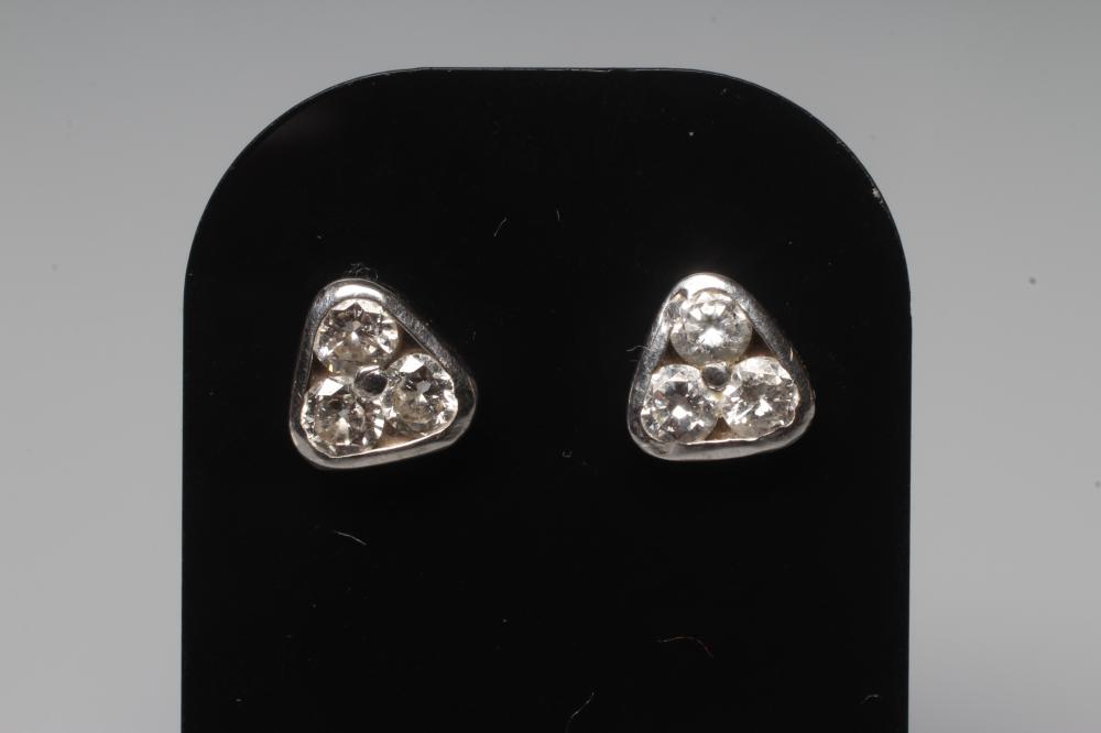 A PAIR OF DIAMOND EAR STUDS, the triangular panels each set with three brilliant cut stones to Image