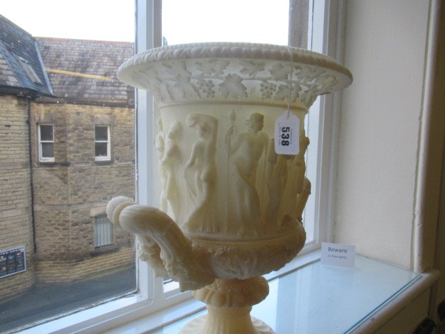 A CARVED ALABASTER URN - After the Antique, of campana form with ovolu rim, over a frieze of Image