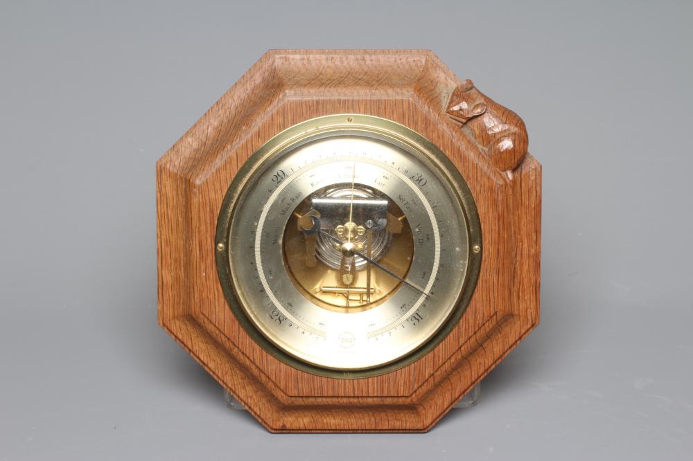 A ROBERT THOMPSON ENGLISH OAK BAROMETER, with carved mouse signature, the octagonal frame mounted Image