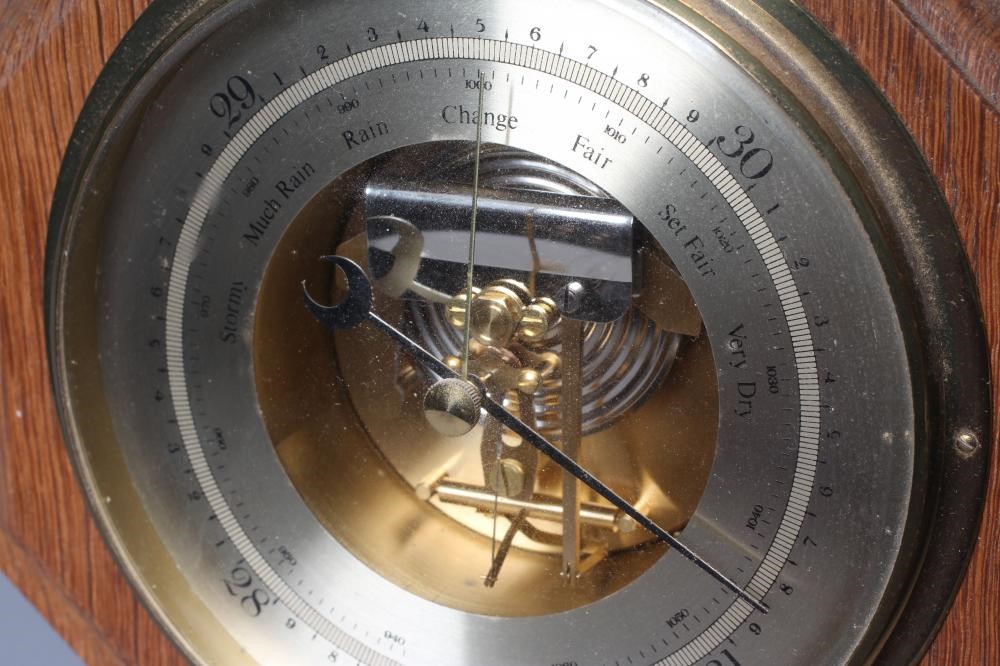 A ROBERT THOMPSON ENGLISH OAK BAROMETER, with carved mouse signature, the octagonal frame mounted Image