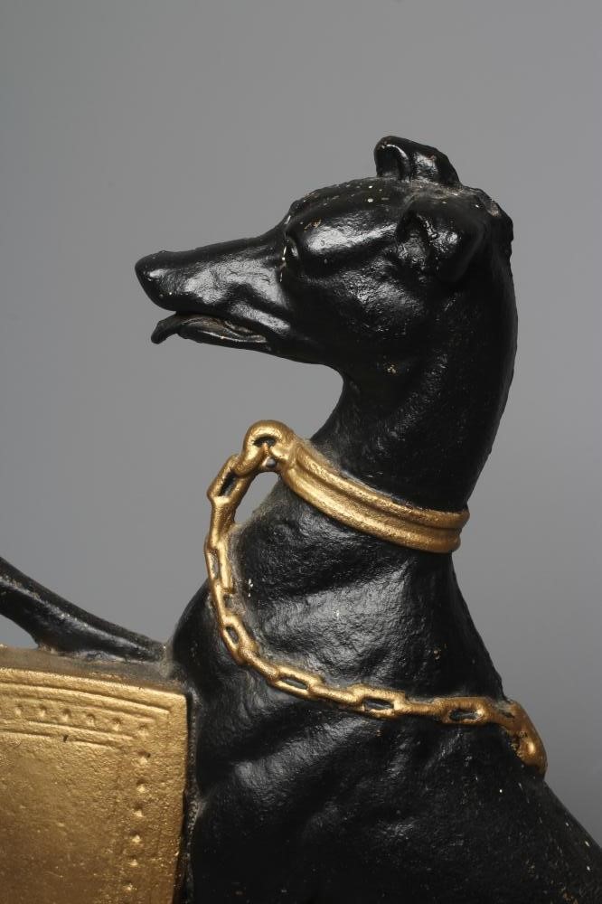 AN EDWARDIAN CAST IRON DOORSTOP of heraldic design with a lurcher holding a shield, painted in black Image