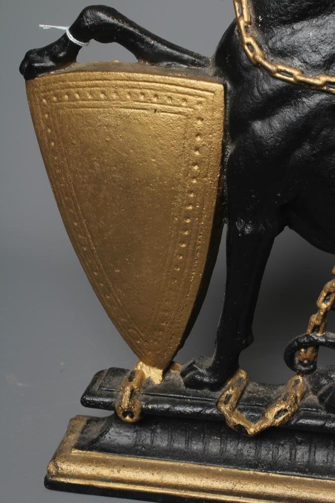 AN EDWARDIAN CAST IRON DOORSTOP of heraldic design with a lurcher holding a shield, painted in black Image
