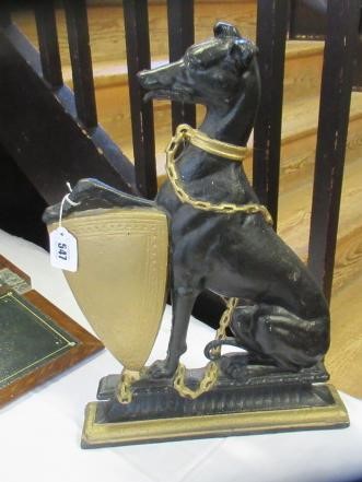 AN EDWARDIAN CAST IRON DOORSTOP of heraldic design with a lurcher holding a shield, painted in black Image