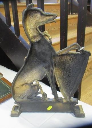 AN EDWARDIAN CAST IRON DOORSTOP of heraldic design with a lurcher holding a shield, painted in black Image