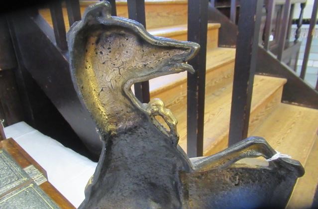 AN EDWARDIAN CAST IRON DOORSTOP of heraldic design with a lurcher holding a shield, painted in black Image