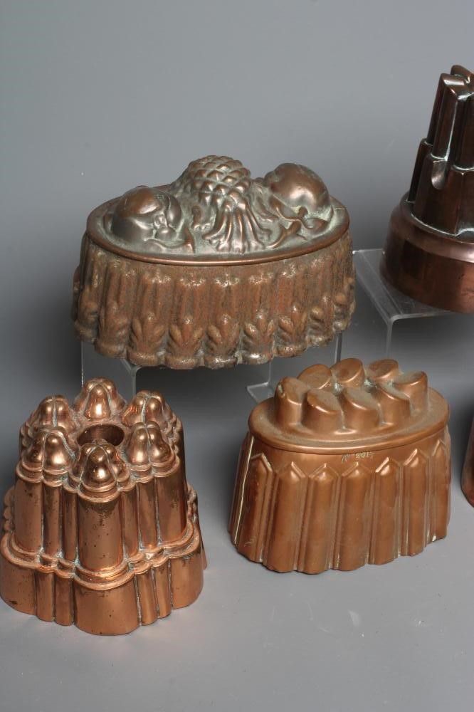 SEVEN VICTORIAN COPPER JELLY MOULDS comprising of five oval examples Image