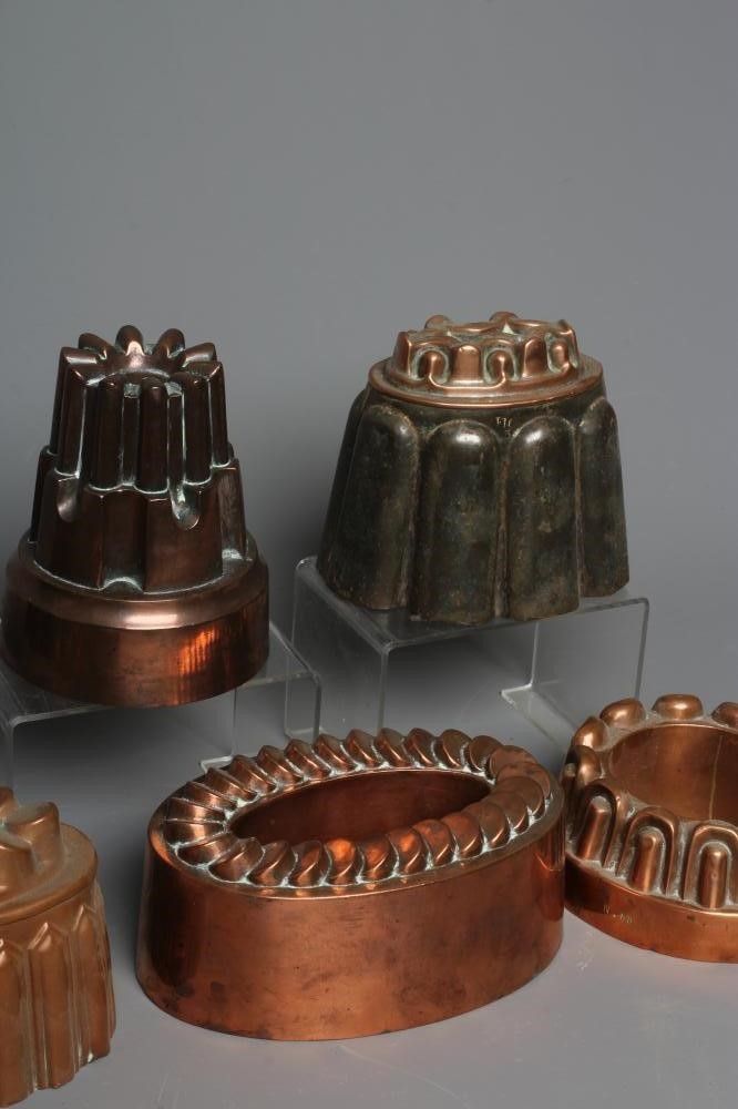 SEVEN VICTORIAN COPPER JELLY MOULDS comprising of five oval examples Image