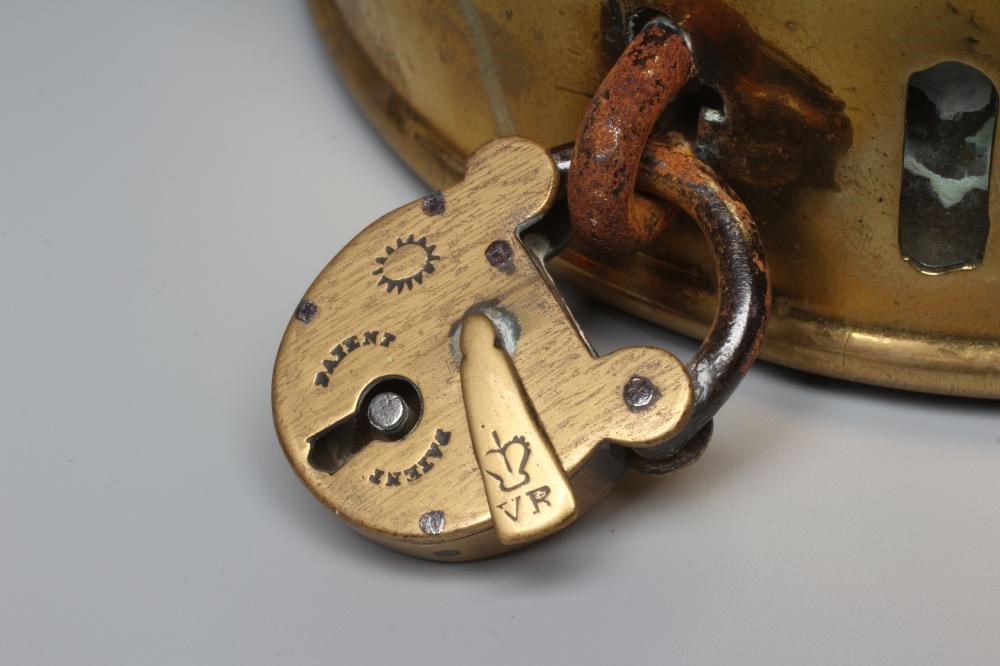 A LARGE 19TH CENTURY BRASS DOG COLLAR, un-named, plain circular with swivel loop and Victorian brass Image
