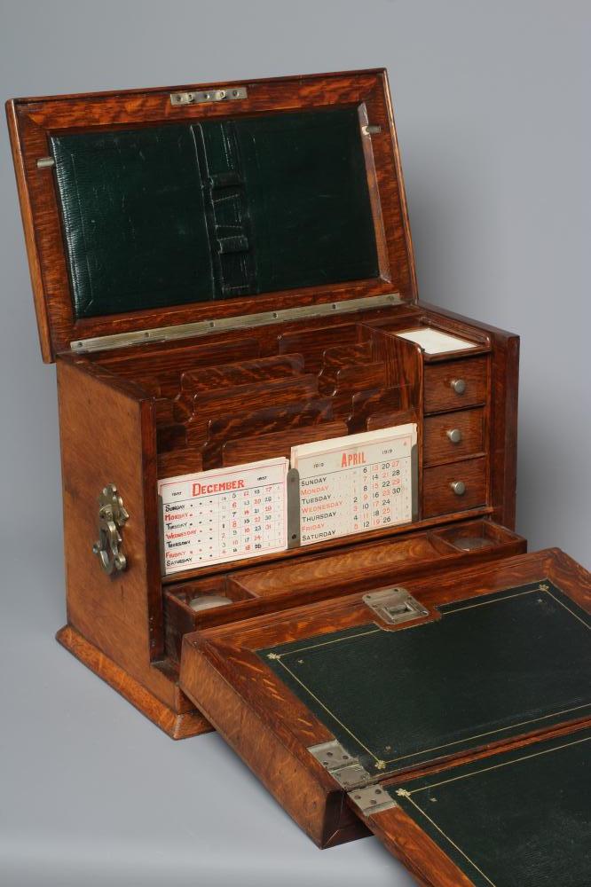 AN EDWARDIAN OAK STATIONERY BOX of oblong form with lightly domed hinged top and two brass handles Image