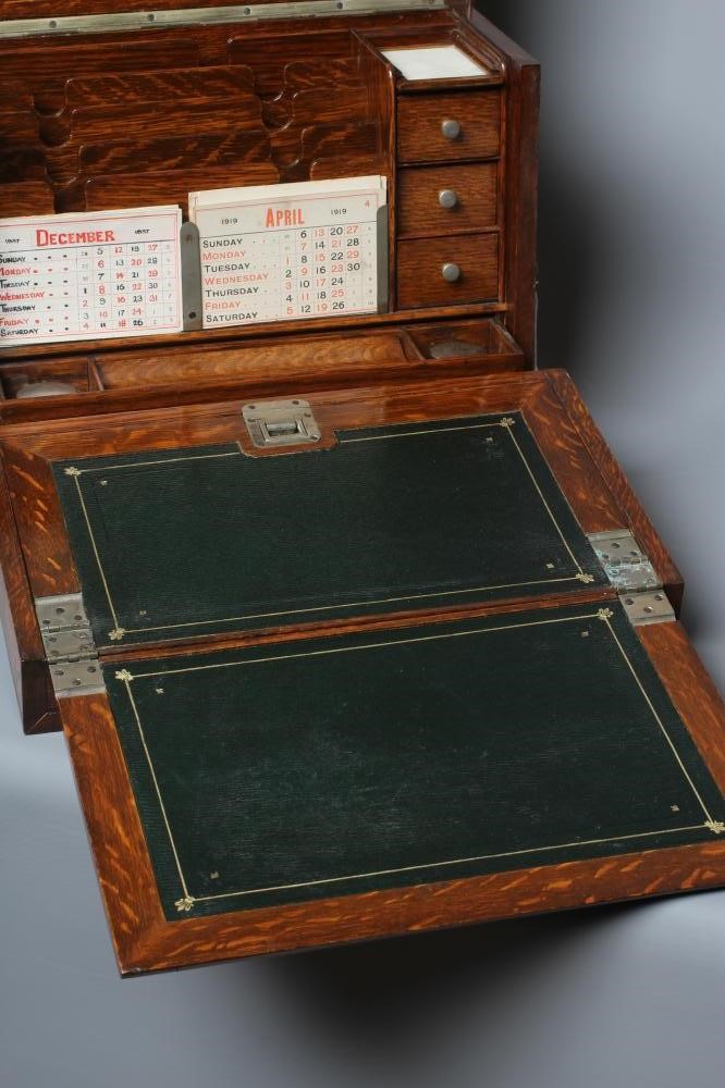AN EDWARDIAN OAK STATIONERY BOX of oblong form with lightly domed hinged top and two brass handles Image