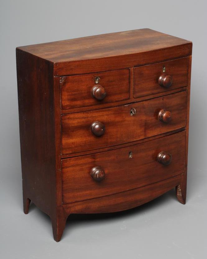 A 19TH CENTURY MINIATURE MAHOGANY BOW FRONT CHEST OF DRAWERS, the oblong top above two short and Image