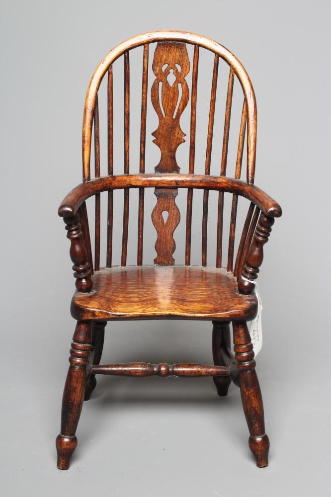 A MINIATURE ASH WINDSOR ARMCHAIR of high hoop spindle back form with carved central splat and ring Image