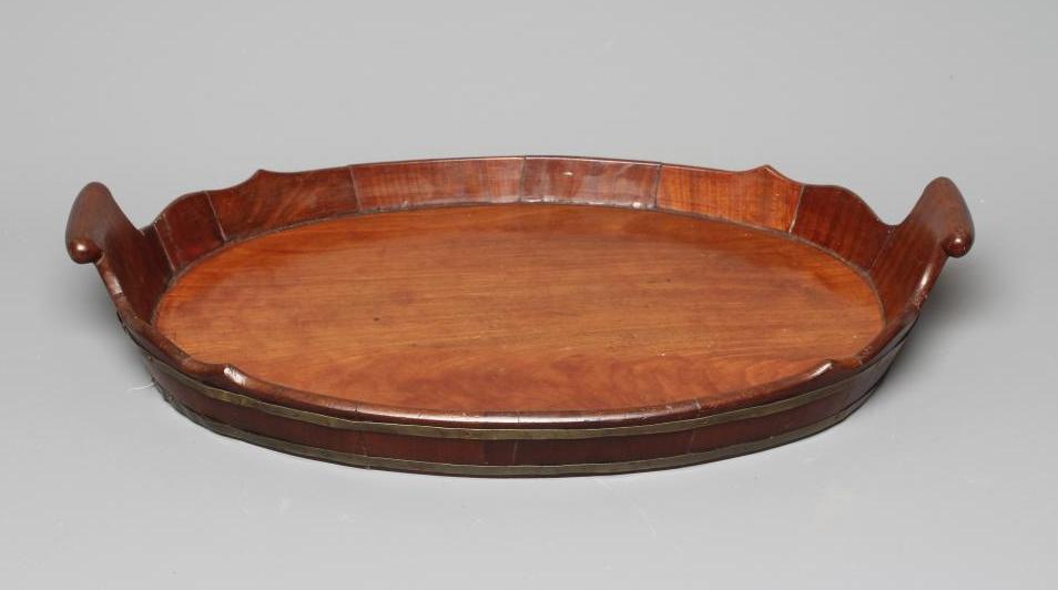 A GEORGE III MAHOGANY BRASS BOUND OVAL TRAY with shaped gallery and turned wood carrying handles, 3 Image