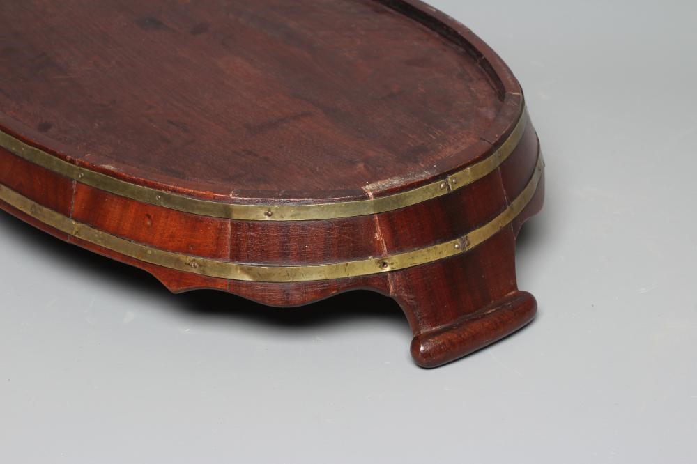 A GEORGE III MAHOGANY BRASS BOUND OVAL TRAY with shaped gallery and turned wood carrying handles, 3 Image