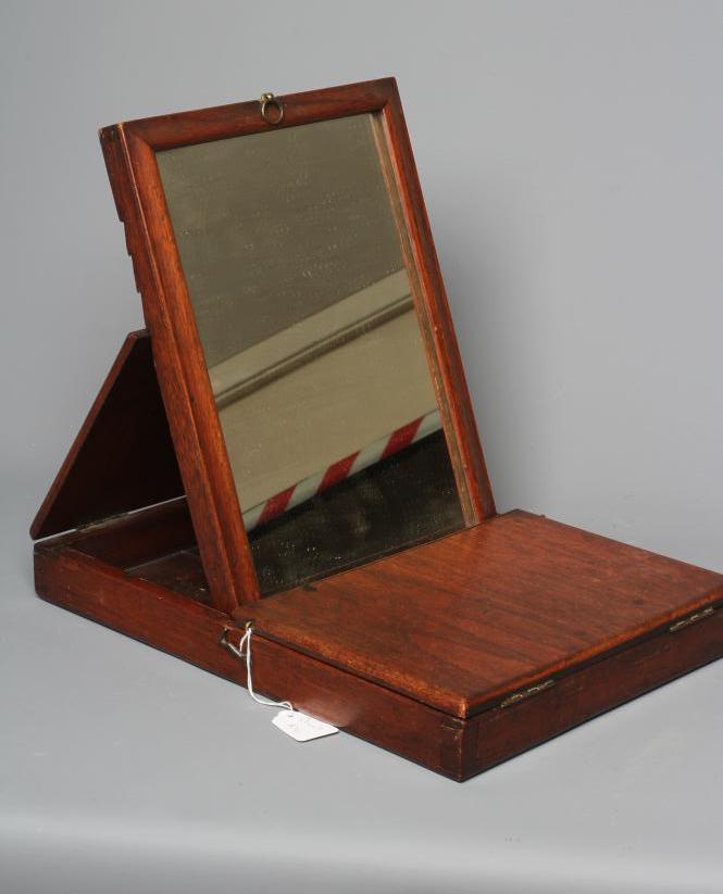 A 19TH CENTURY FOLDING CAMPAIGN TOILET MIRROR, the oblong plate in a moulded frame folding into a Image