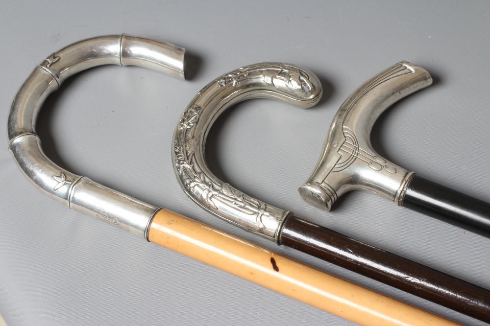 A GERMAN SILVER CRUTCH HANDLE WALKING STICK with Art Nouveau style embossed decoration Image
