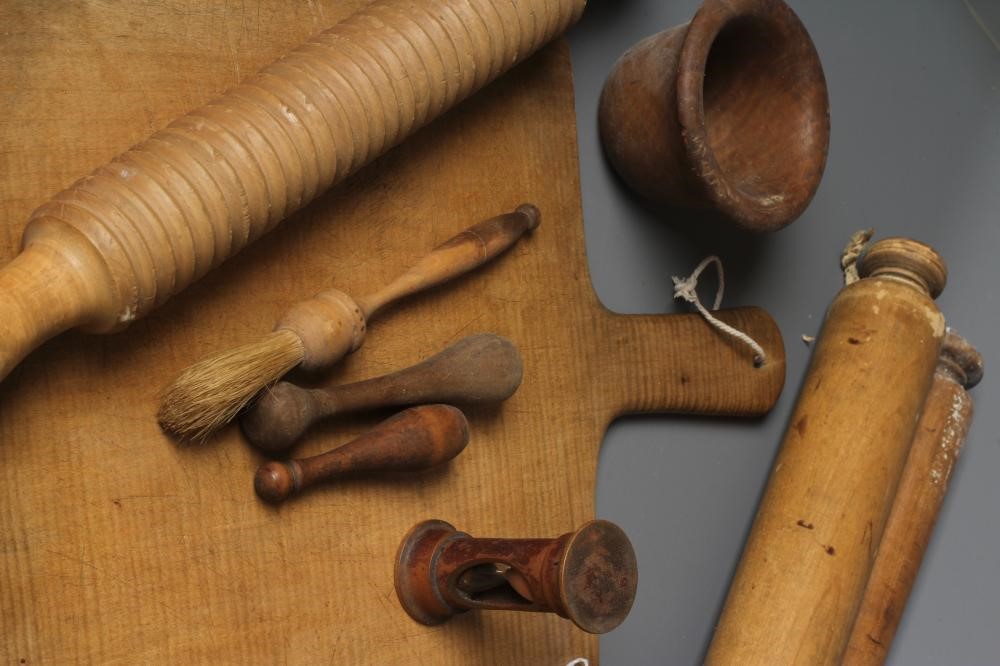 A COLLECTION OF VICTORIAN KITCHENALIA, comprising of a chopping board, six butter pats, butter Image