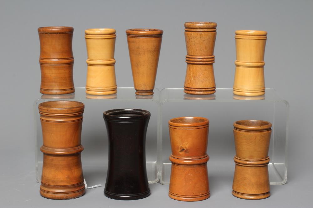 NINE 19TH CENTURY TREEN AND LIGNUM VITAE DICE SHAKERS of waisted form with exterior mouldings and Image