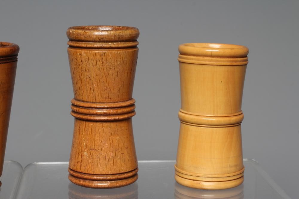 NINE 19TH CENTURY TREEN AND LIGNUM VITAE DICE SHAKERS of waisted form with exterior mouldings and Image