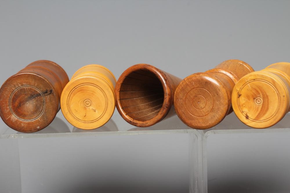 NINE 19TH CENTURY TREEN AND LIGNUM VITAE DICE SHAKERS of waisted form with exterior mouldings and Image