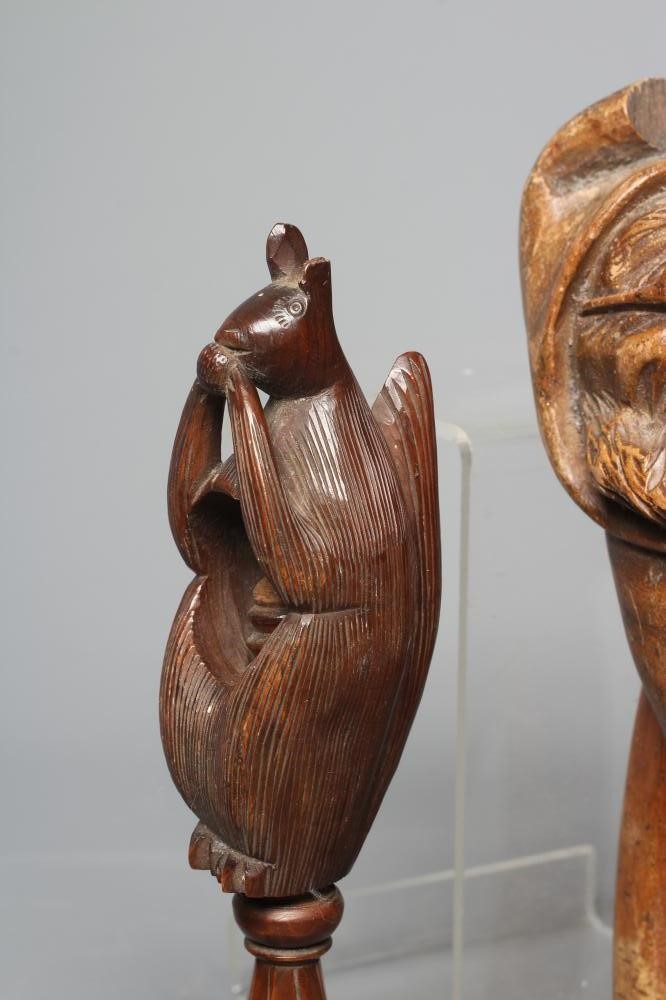A 19TH CENTURY TREEN SCREW TYPE NUTCRACKER carved as a squirrel eating a nut Image