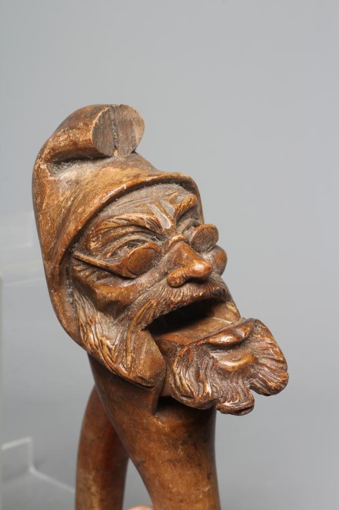 A 19TH CENTURY TREEN SCREW TYPE NUTCRACKER carved as a squirrel eating a nut Image