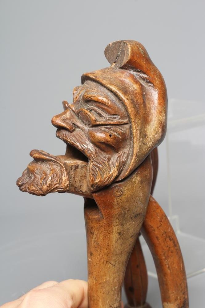 A 19TH CENTURY TREEN SCREW TYPE NUTCRACKER carved as a squirrel eating a nut Image