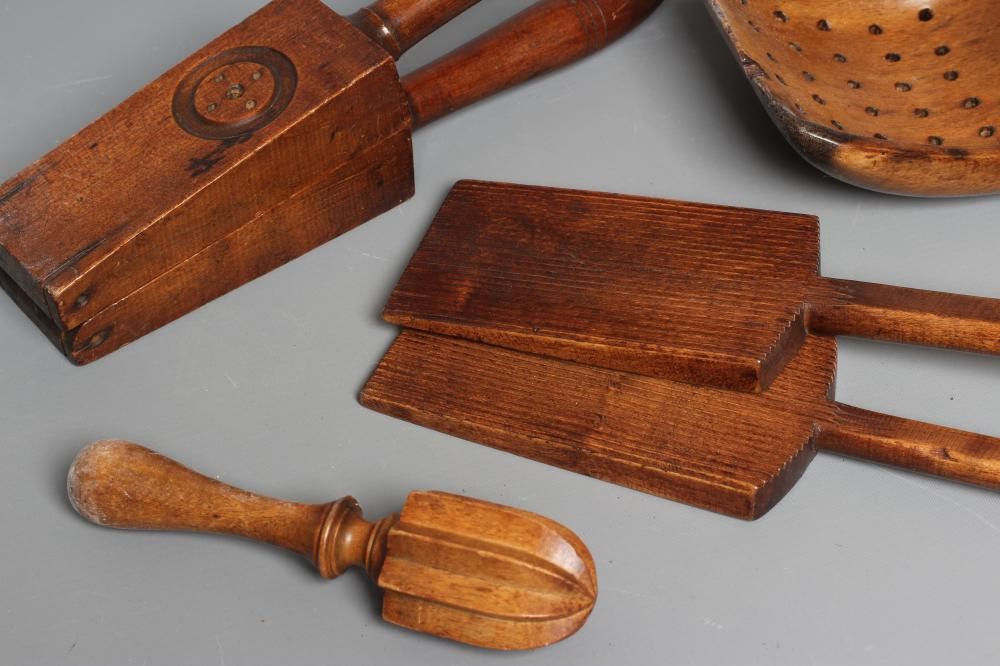 A COLLECTION OF 19TH CENTURY TREEN KITCHENALIA, comprising of a butter spoon, lemon squeezer, butter Image