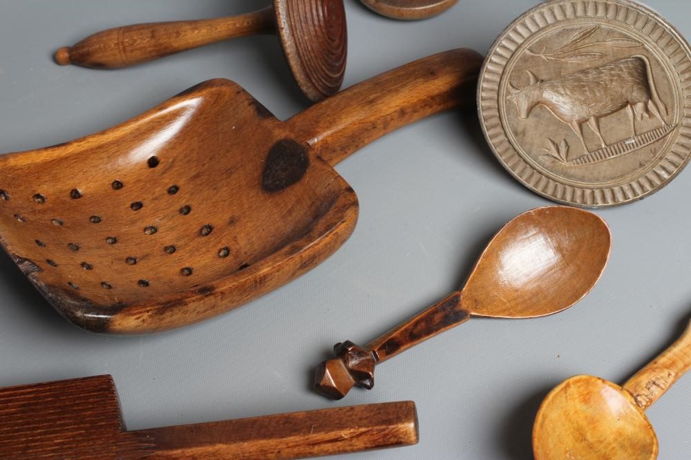A COLLECTION OF 19TH CENTURY TREEN KITCHENALIA, comprising of a butter spoon, lemon squeezer, butter Image