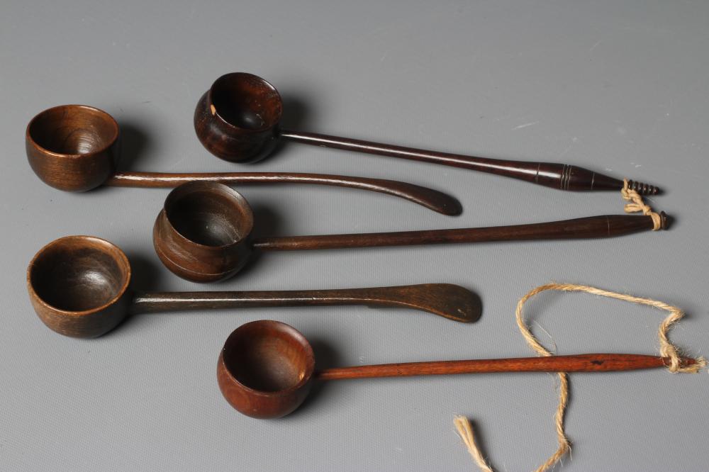 FIVE 19TH CENTURY TREEN TODDY LADLES each with rounded bowl and protruding lip, three with rounded Image