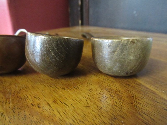 FIVE 19TH CENTURY TREEN TODDY LADLES each with rounded bowl and protruding lip, three with rounded Image
