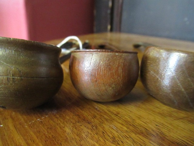 FIVE 19TH CENTURY TREEN TODDY LADLES each with rounded bowl and protruding lip, three with rounded Image