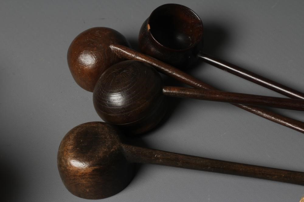 FIVE 19TH CENTURY TREEN TODDY LADLES each with rounded bowl and protruding lip, three with rounded Image