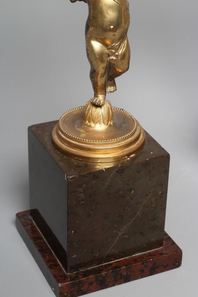 A PAIR OF ORMOLU CHERUB AND FOLIATE TWO BRANCH CANDELABRA raised on square marble plinth bases, each Image