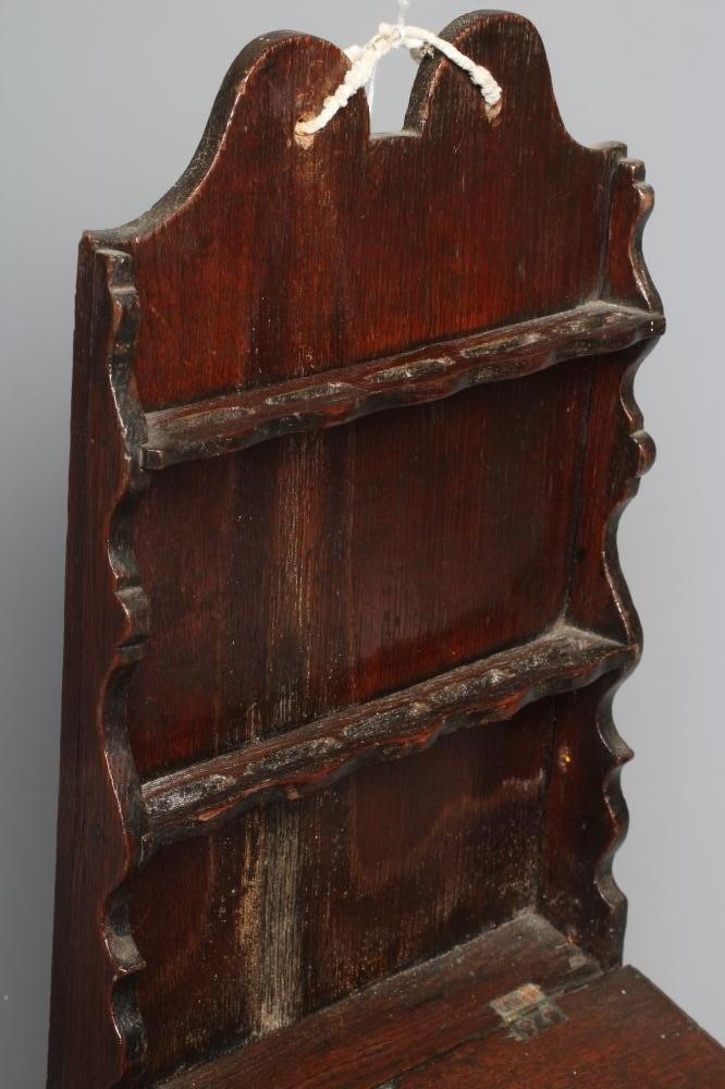 A 19TH CENTURY OAK WALL MOUNTED SPOON RACK with shaped cresting rail and two shelves for spoons Image