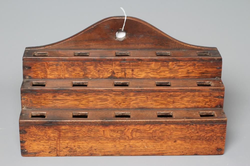 AN EARLY 19TH CENTURY OAK TABLE TOP SPOON RACK, the shaped cresting rail above three tiers of Image