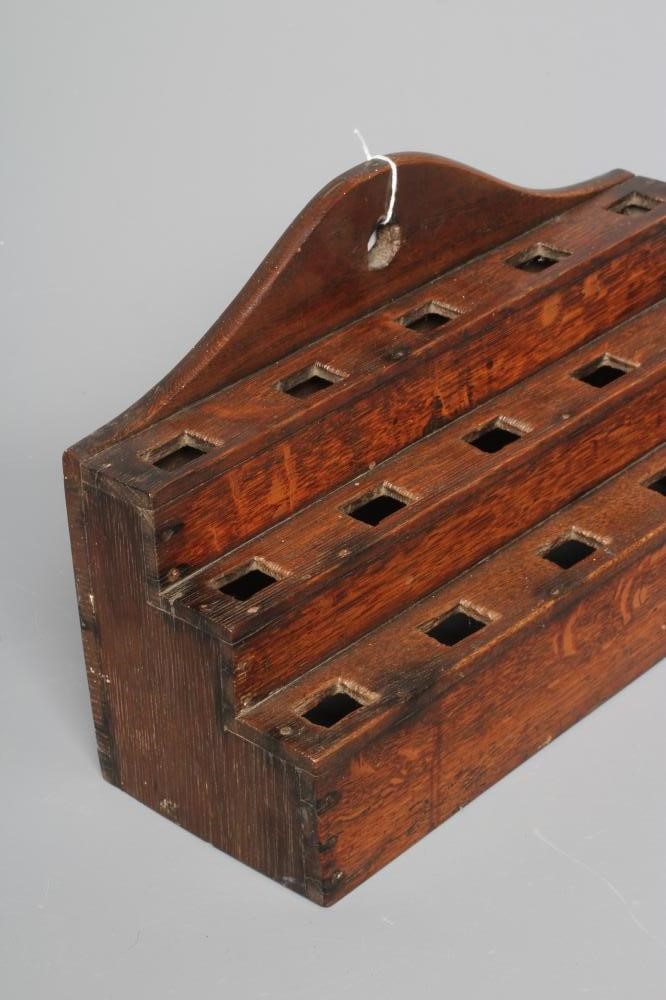 AN EARLY 19TH CENTURY OAK TABLE TOP SPOON RACK, the shaped cresting rail above three tiers of Image