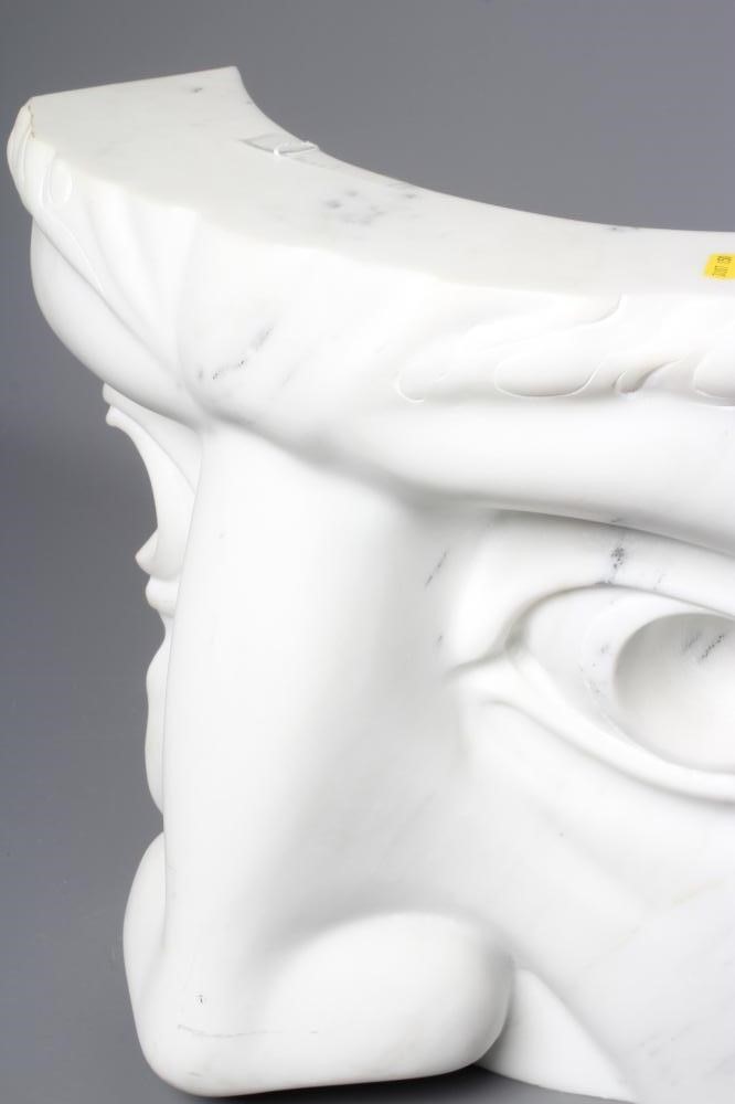 A ROMAN STYLE CONCAVE WHITE MARBLE SCULPTURE, in the form of a fragment of a face, with incised leaf Image