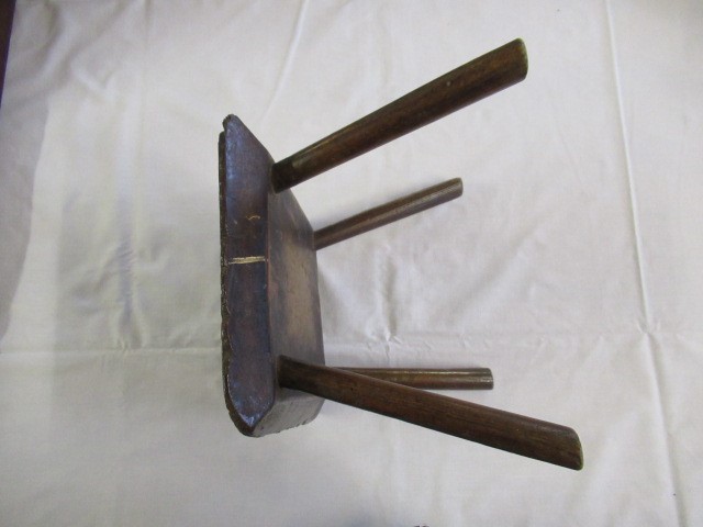 A 19TH CENTURY ASH AND ELM MILKING STOOL, the oblong seat raised on four circular tapering legs, 13 Image