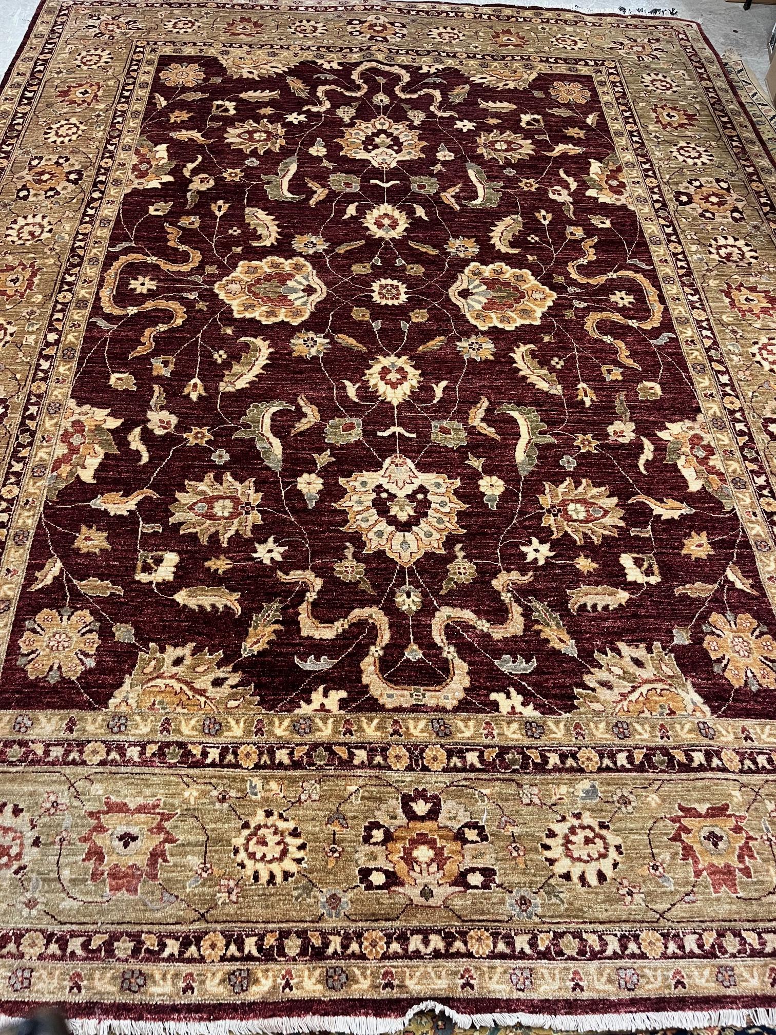 A PAKISTANI FARAHAN ZEIGLER TYPE CARPET, modern, the sang de bouef field with palmettes and trailing Image
