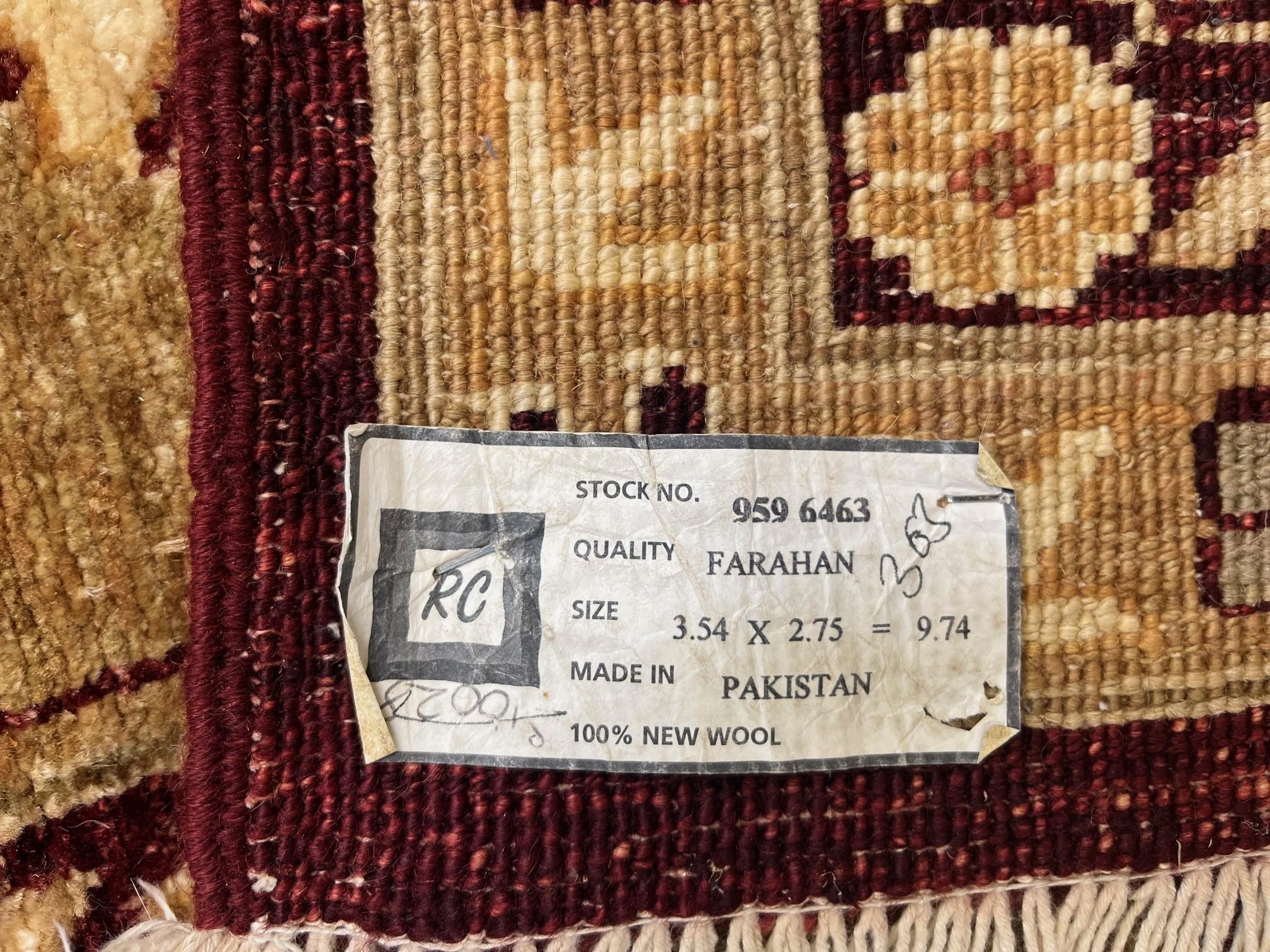 A PAKISTANI FARAHAN ZEIGLER TYPE CARPET, modern, the sang de bouef field with palmettes and trailing Image