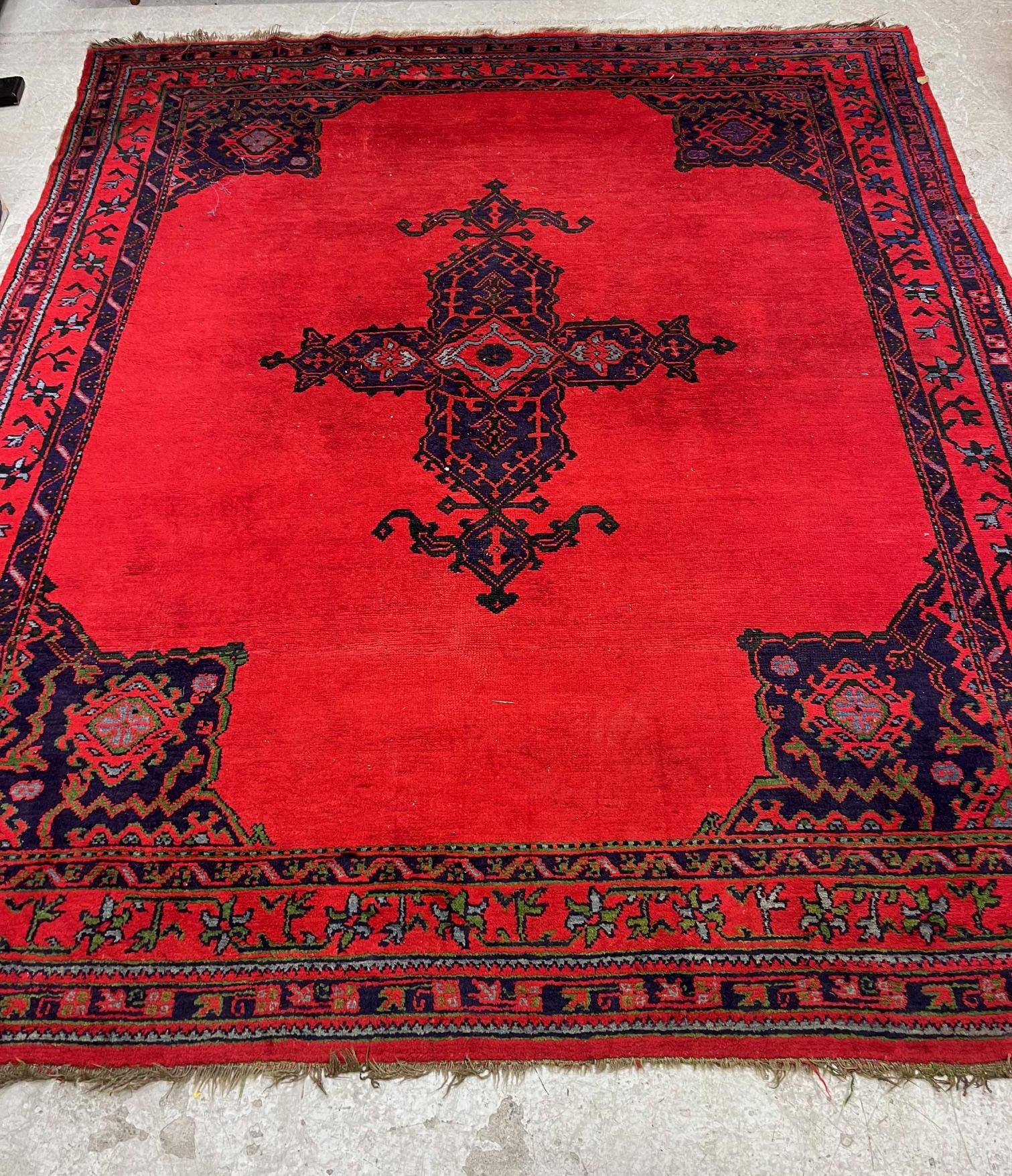 A TURKISH USHAK RED GROUND WOOL CARPET Image