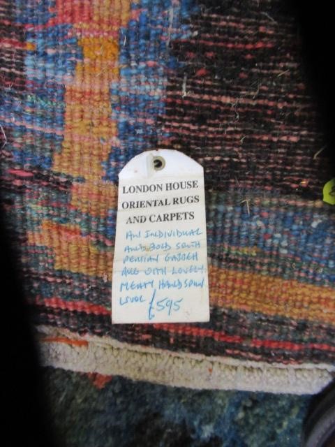 A SOUTH PERSIAN GABBEH RUG, the deep pile with a grid pattern in shades of blue, green, ochre and Image