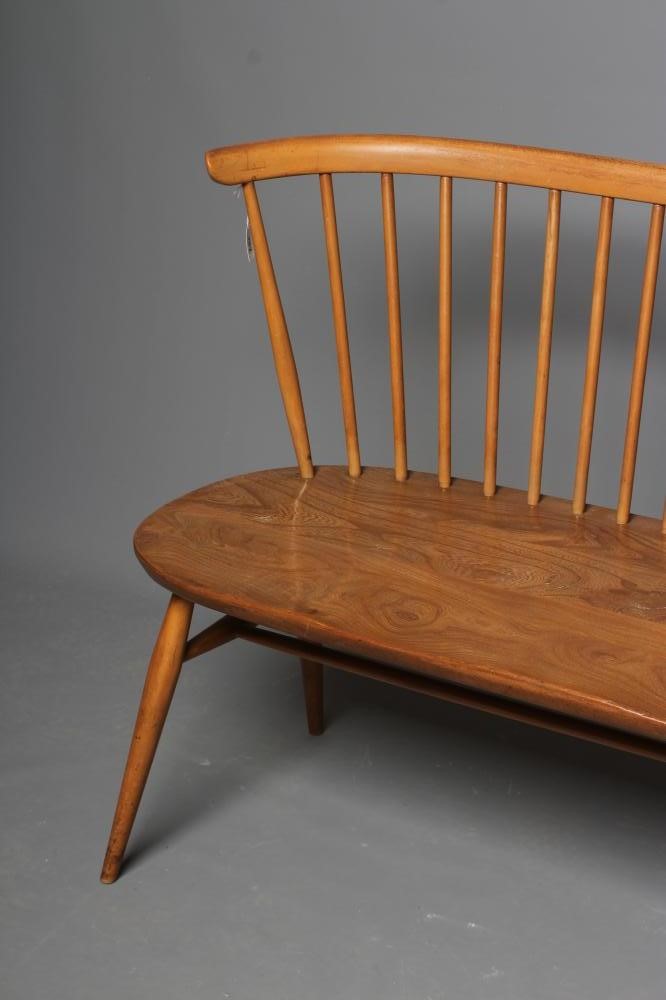 AN ERCOL BEECH AND ELM LOVE SEAT Image