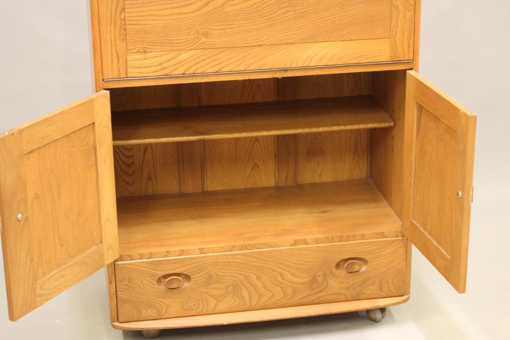 AN ERCOL ELM SECRETAIRE CABINET Image